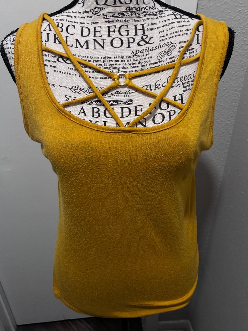HIPPIE CHIC USA mustard yellow tank top featuring a criss-cross cage neckline